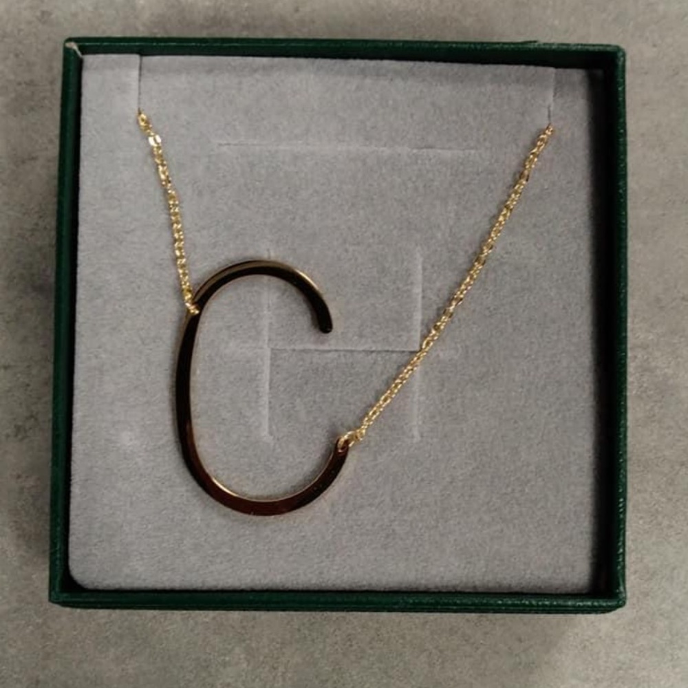 Letter “C” Necklace on gold chain.